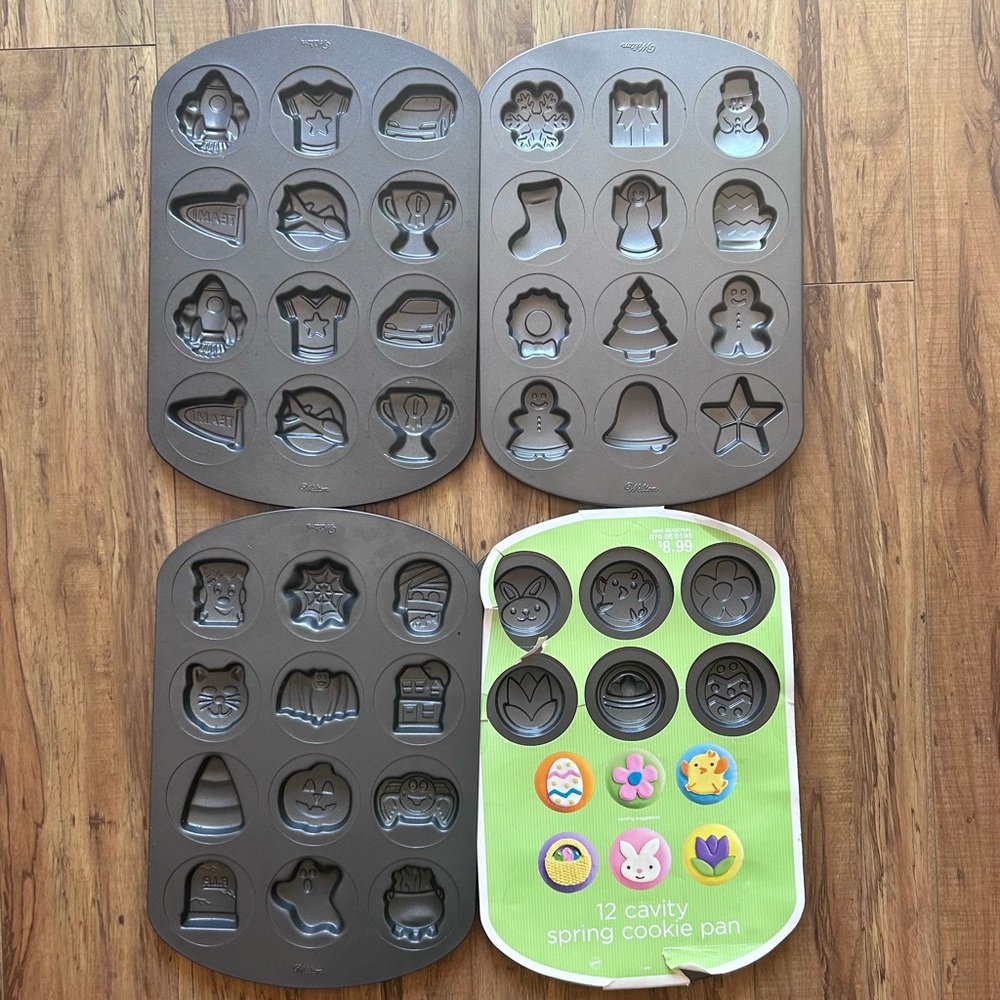 Bundle of 4 Wilton shapes cookie sheets - Christmas; Halloween, Spring, Sports